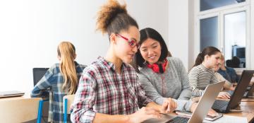 Two high school girls working on a laptop