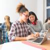 Two high school girls working on a laptop